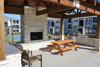 Outdoor lounge with fireplace and grill station